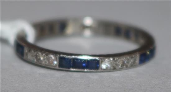 A platinum sapphire and diamond set full eternity ring, size M.